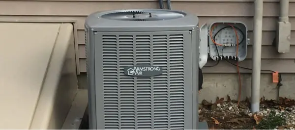 Armstrong Air condenser next to a house ready for a tune-up
