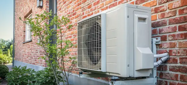 Ductless mini-split outdoor unit on a brick wall